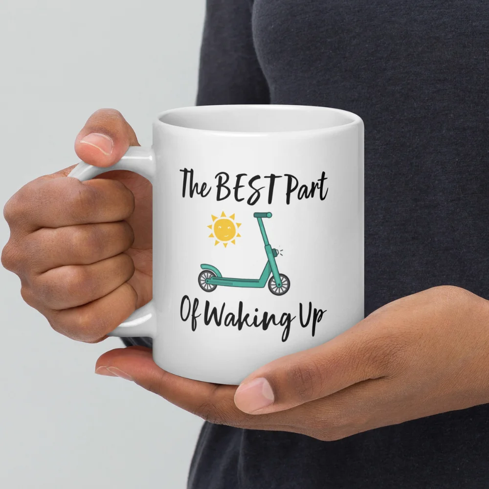 A person holding a Funny E-Scooter Coffee Mug: The Best Part Of Waking Up