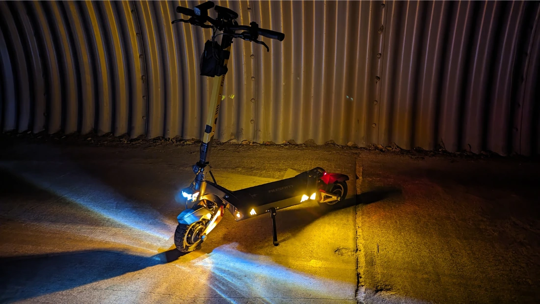 a picture of the ausom gallop scooter at night showing its lights